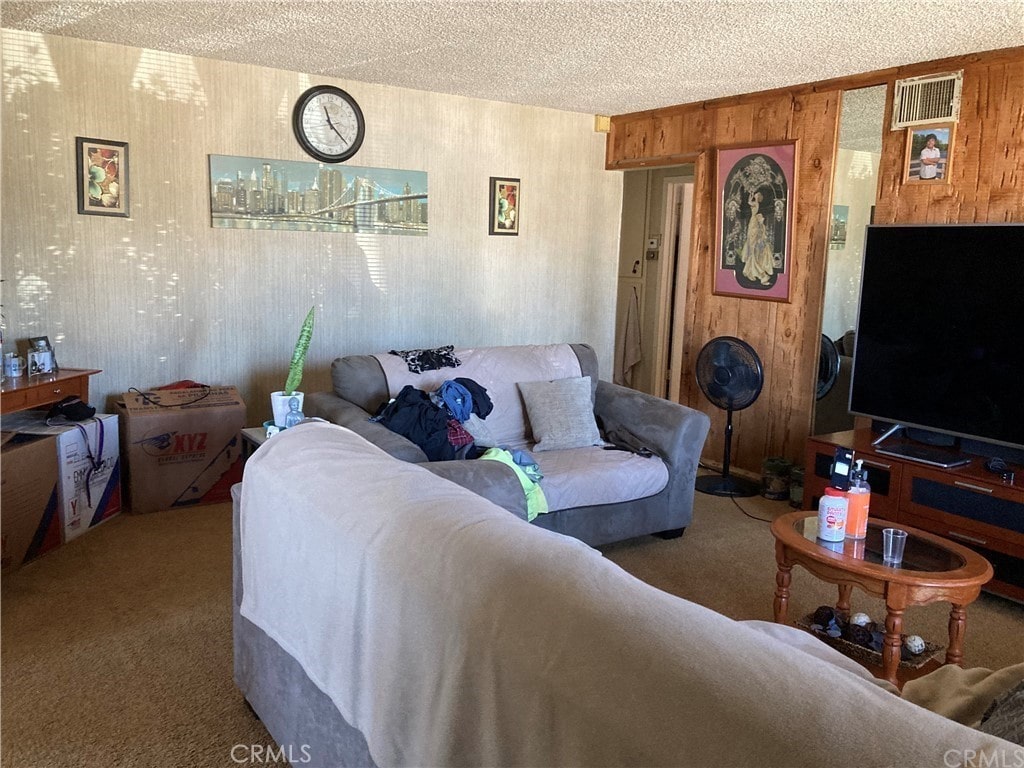 18708 Fieldbrook St, Rowland Heights, CA 91748 - living area featuring carpet, wooden walls, and a textured ceiling