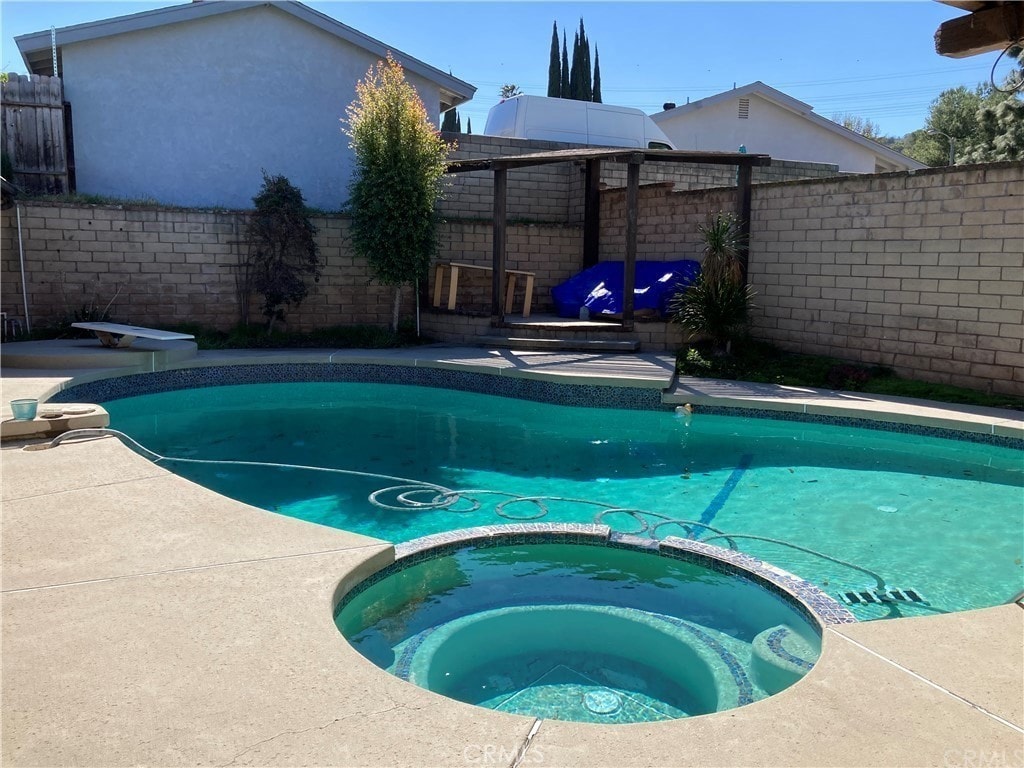 18708 Fieldbrook St, Rowland Heights, CA 91748 - view of pool featuring a fenced backyard, a diving board, and a pool with connected hot tub