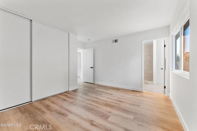 36848 Apache Plume Dr, Palmdale, CA 93550 - unfurnished bedroom featuring light wood finished floors, a closet, and ensuite bathroom