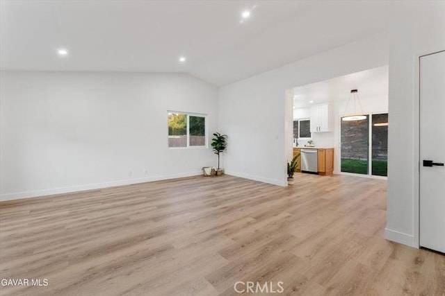 36848 Apache Plume Dr, Palmdale, CA 93550 - unfurnished living room with lofted ceiling, light wood-style floors, and recessed lighting