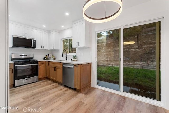 36848 Apache Plume Dr, Palmdale, CA 93550 - kitchen with appliances with stainless steel finishes, light countertops, white cabinets, light wood finished floors, and recessed lighting