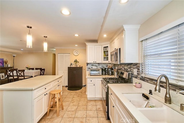 8757 Los Altos Dr, Buena Park, CA 90620 - kitchen featuring appliances with stainless steel finishes, a kitchen breakfast bar, tasteful backsplash, recessed lighting, and white cabinetry