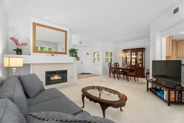 2303 Paseo Circulo, Tustin, CA 92782 - living room with light carpet, a tile fireplace, and a chandelier