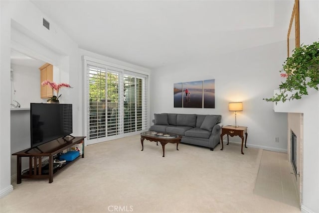 2303 Paseo Circulo, Tustin, CA 92782 - living room with light colored carpet and a glass covered fireplace