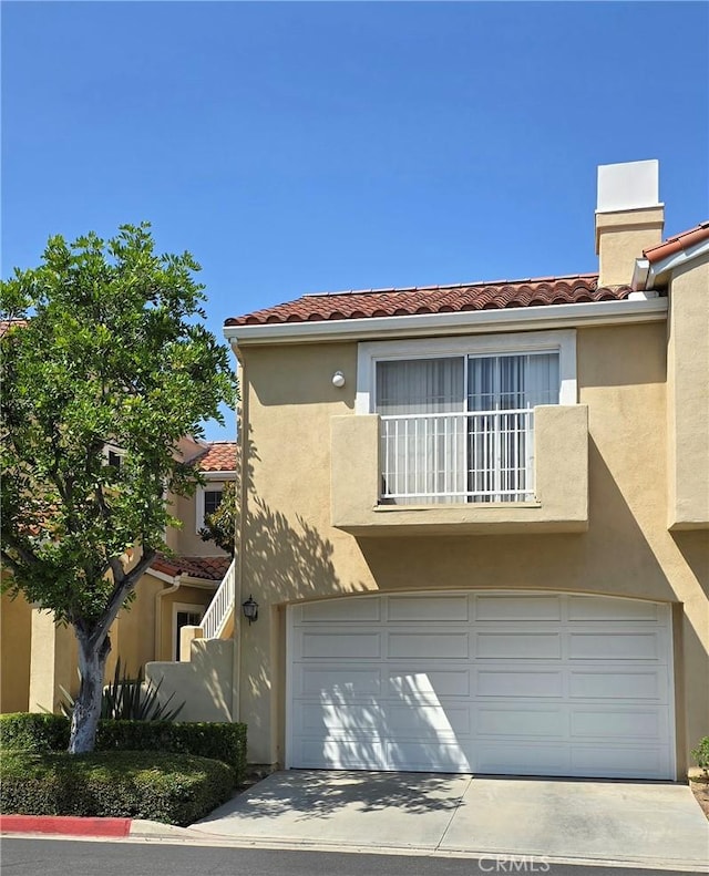 2303 Paseo Circulo, Tustin, CA 92782 - view of front of house with a tile roof, an attached garage, stucco siding, and driveway