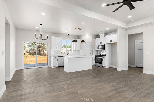 6388 Oak Rd, Paradise, CA 95969 - kitchen featuring stainless steel appliances, open floor plan, white cabinetry, tasteful backsplash, and recessed lighting