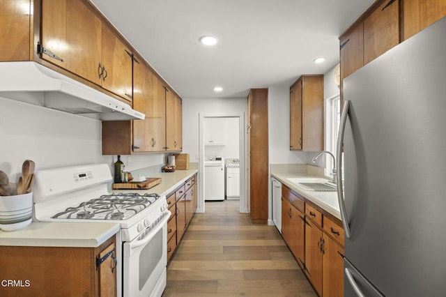 80 Watkins Way, Oak View, CA 93022 - kitchen with white appliances, under cabinet range hood, light wood-type flooring, brown cabinets, and recessed lighting