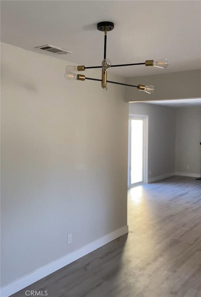 3195 Camarillo Ave, Oceanside, CA 92056 - empty room featuring wood finished floors and a chandelier