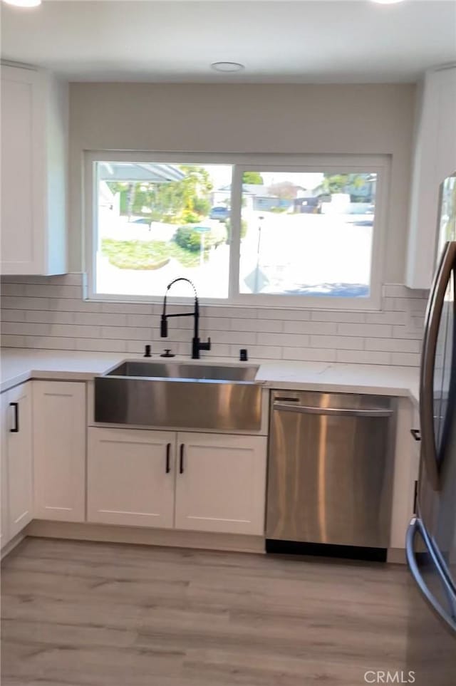 3195 Camarillo Ave, Oceanside, CA 92056 - kitchen featuring appliances with stainless steel finishes, white cabinets, and plenty of natural light