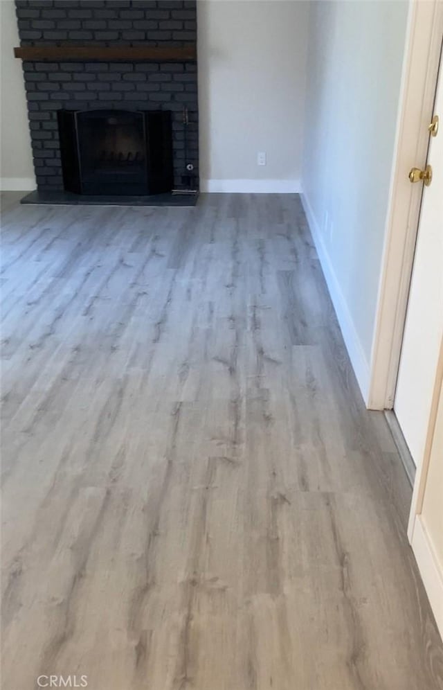 3195 Camarillo Ave, Oceanside, CA 92056 - unfurnished living room featuring wood finished floors and a fireplace