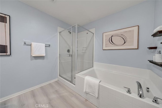 7265 Enclave Dr, Eastvale, CA 92880 - full bath featuring a garden tub, a stall shower, and wood finished floors