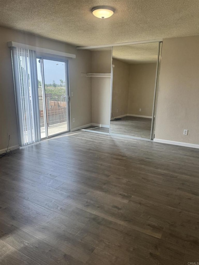 384 I St, Chula Vista, CA 91910 - unfurnished bedroom with a textured ceiling, access to exterior, dark wood-type flooring, and a closet