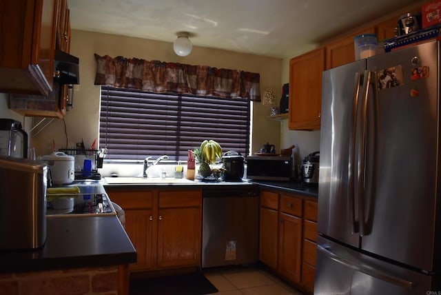 384 I St, Chula Vista, CA 91910 - kitchen featuring stainless steel appliances, brown cabinetry, light tile patterned floors, and ventilation hood