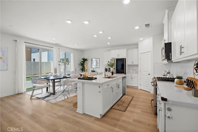 2239 Melogold Way, Corona, CA 92883 - kitchen featuring stainless steel appliances, light countertops, white cabinets, tasteful backsplash, and recessed lighting