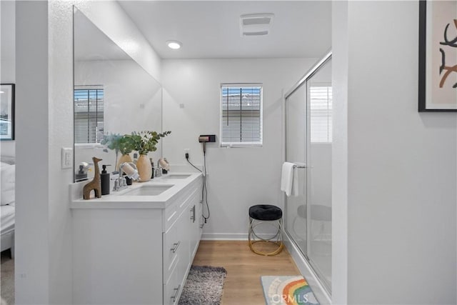 2239 Melogold Way, Corona, CA 92883 - full bathroom with double vanity, a shower stall, wood finished floors, and connected bathroom
