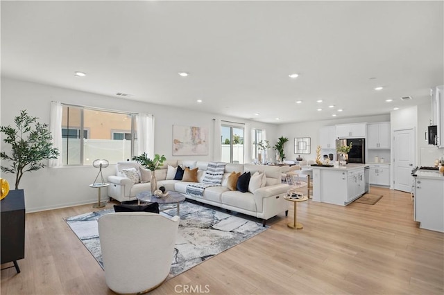 2239 Melogold Way, Corona, CA 92883 - living area featuring light wood finished floors and recessed lighting
