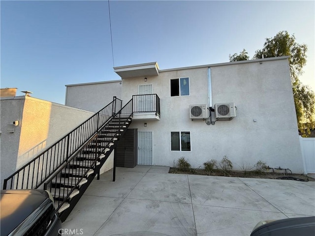 11125 Glenoaks Blvd, Pacoima, CA 91331 - back of property with stairs, stucco siding, and a patio
