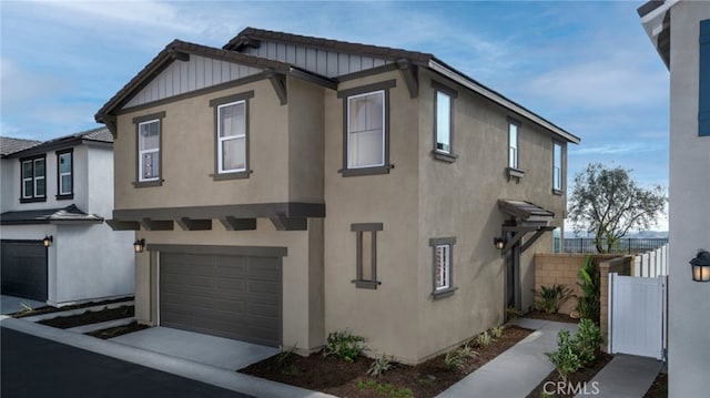 338 Fowler Way, Rialto, CA 92377 - view of front of home featuring stucco siding, board and batten siding, and a garage