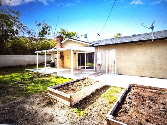 2756 Gallio Ave, Rowland Heights, CA 91748 - back of house with a vegetable garden, a patio, a chimney, and stucco siding