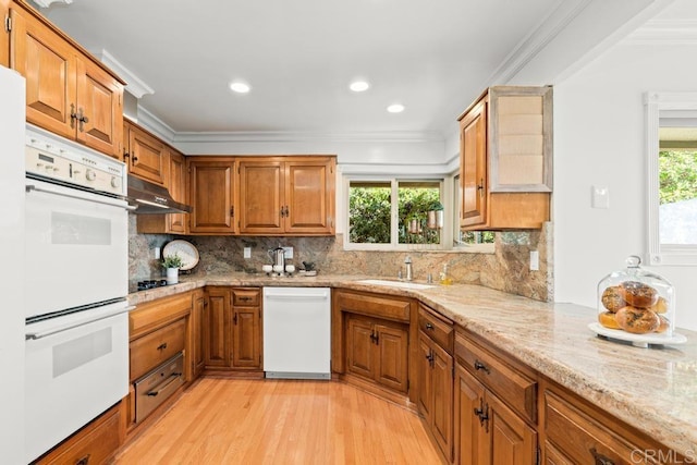 5946 Overlake Ave, Del Cerro, CA 92120 - kitchen with white appliances, light wood finished floors, under cabinet range hood, brown cabinetry, and crown molding