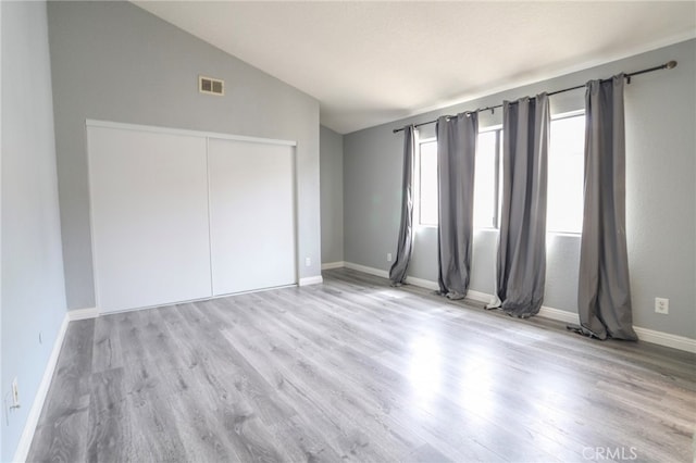 1818 W 145th St Unit 1, Gardena, CA 90249 - unfurnished bedroom with lofted ceiling, wood finished floors, and a closet