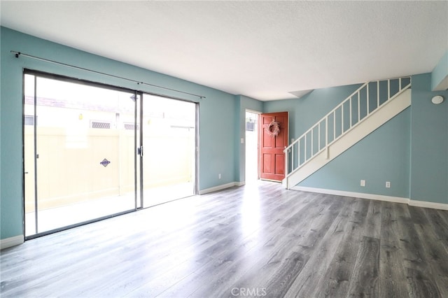 1818 W 145th St Unit 1, Gardena, CA 90249 - unfurnished living room with wood finished floors, stairway, and a textured ceiling