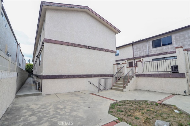 1818 W 145th St Unit 1, Gardena, CA 90249 - rear view of house featuring stucco siding and a patio area