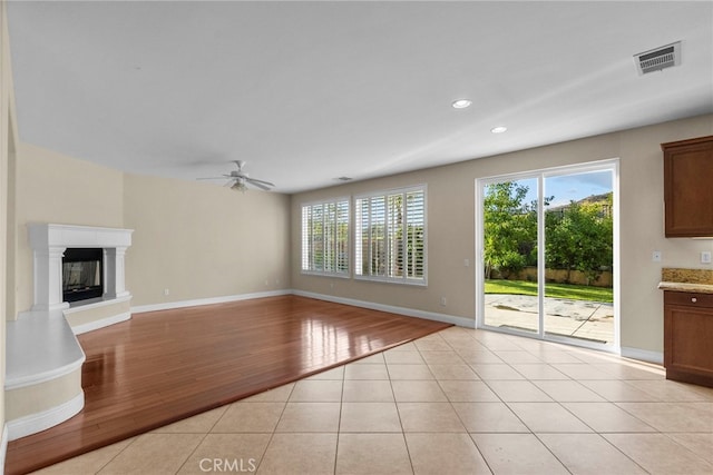 29243 Discovery Ridge Dr, Saugus, CA 91390 - unfurnished living room featuring ceiling fan, light wood-style flooring, recessed lighting, and a glass covered fireplace