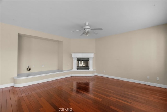 29243 Discovery Ridge Dr, Saugus, CA 91390 - unfurnished living room featuring hardwood / wood-style flooring, a ceiling fan, and a glass covered fireplace