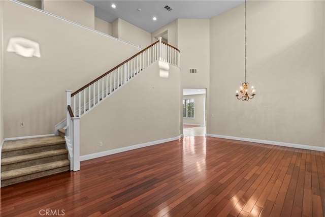 29243 Discovery Ridge Dr, Saugus, CA 91390 - unfurnished living room with wood-type flooring, a chandelier, stairway, a towering ceiling, and recessed lighting