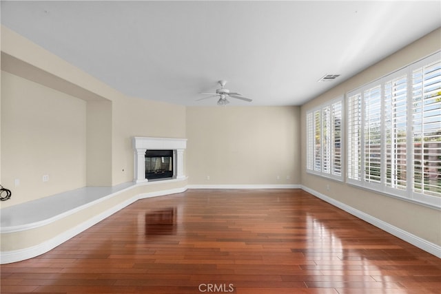 29243 Discovery Ridge Dr, Saugus, CA 91390 - unfurnished living room with wood-type flooring, ceiling fan, and a glass covered fireplace