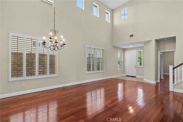 29243 Discovery Ridge Dr, Saugus, CA 91390 - entrance foyer featuring wood-type flooring, a high ceiling, a chandelier, and stairs
