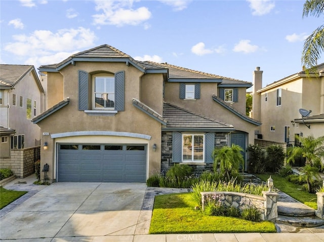 29243 Discovery Ridge Dr, Saugus, CA 91390 - view of front of property featuring a tile roof, a garage, concrete driveway, and stucco siding