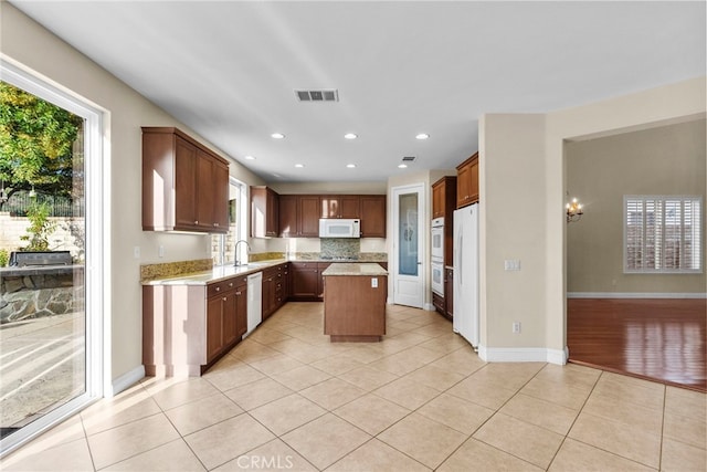 29243 Discovery Ridge Dr, Saugus, CA 91390 - kitchen with white appliances, plenty of natural light, light tile patterned floors, and recessed lighting