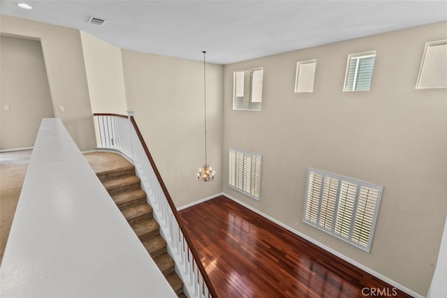 29243 Discovery Ridge Dr, Saugus, CA 91390 - stairway featuring a chandelier and wood finished floors