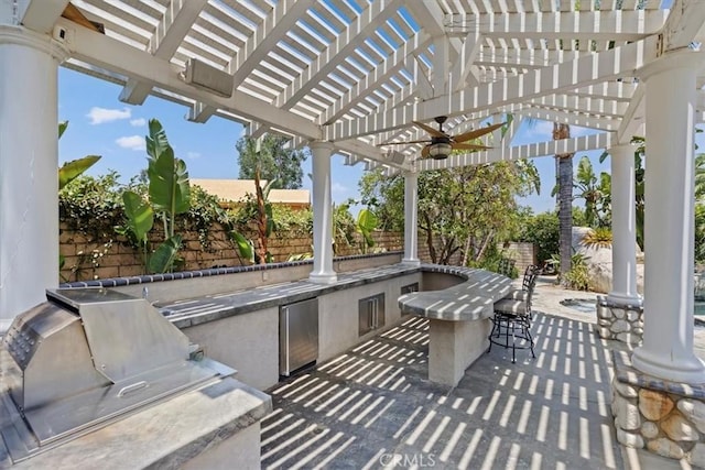10847 Leota Ln, Riverside, CA 92503 - fenced backyard featuring area for grilling, a pergola, a ceiling fan, an outdoor bar, and a patio