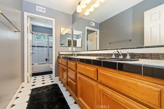 10847 Leota Ln, Riverside, CA 92503 - bathroom featuring double vanity, enclosed tub / shower combo, and tile patterned floors