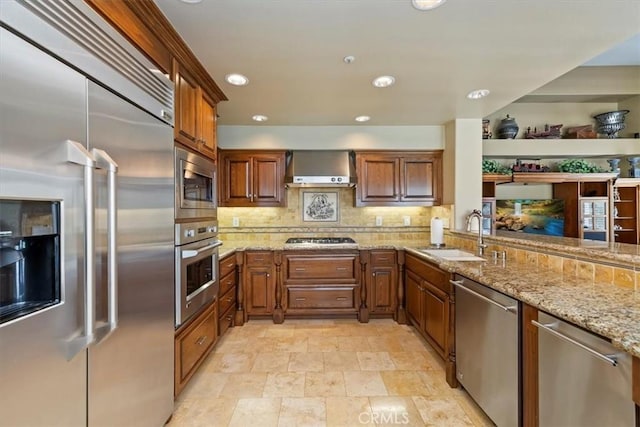 10847 Leota Ln, Riverside, CA 92503 - kitchen with built in appliances, wall chimney range hood, decorative backsplash, light stone countertops, and stone finish floors