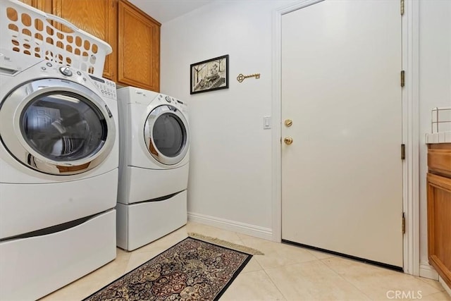 10847 Leota Ln, Riverside, CA 92503 - laundry area featuring separate washer and dryer, cabinet space, and light tile patterned flooring