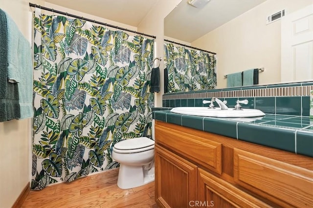 10847 Leota Ln, Riverside, CA 92503 - full bath with vanity, wood finished floors, and a shower with shower curtain