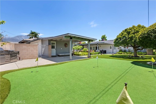 1335 N Vallejo Way, Upland, CA 91786 - rear view of house with an area to practice putting and a patio area