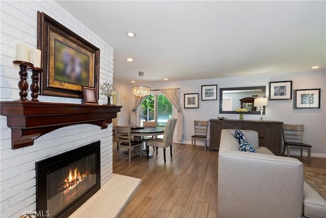 1335 N Vallejo Way, Upland, CA 91786 - living room with a fireplace, light wood-style flooring, recessed lighting, and a chandelier