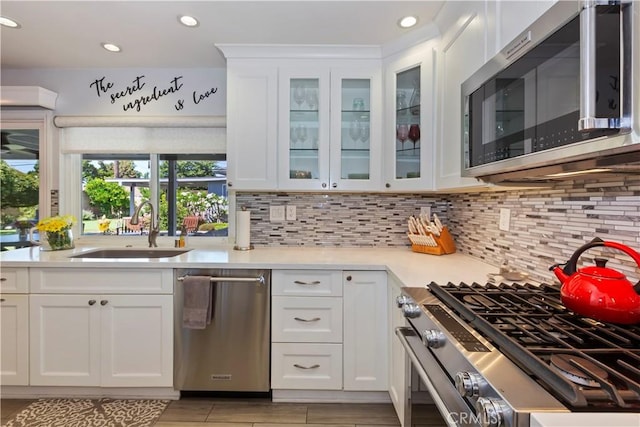 1335 N Vallejo Way, Upland, CA 91786 - kitchen with appliances with stainless steel finishes, light countertops, backsplash, white cabinets, and glass insert cabinets