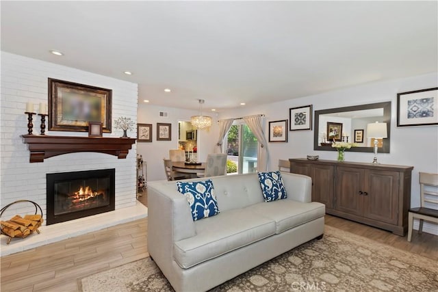 1335 N Vallejo Way, Upland, CA 91786 - living room featuring wood finished floors, recessed lighting, a fireplace, and a chandelier