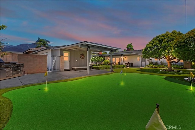 1335 N Vallejo Way, Upland, CA 91786 - back of house at dusk with an area to practice putting and a patio