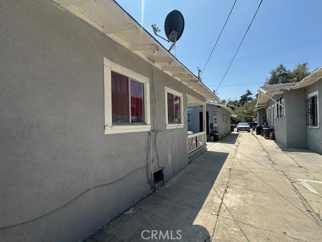 2132 Lincoln Park Ave, Lincoln Heights, CA 90031 - view of side of home featuring stucco siding and a patio