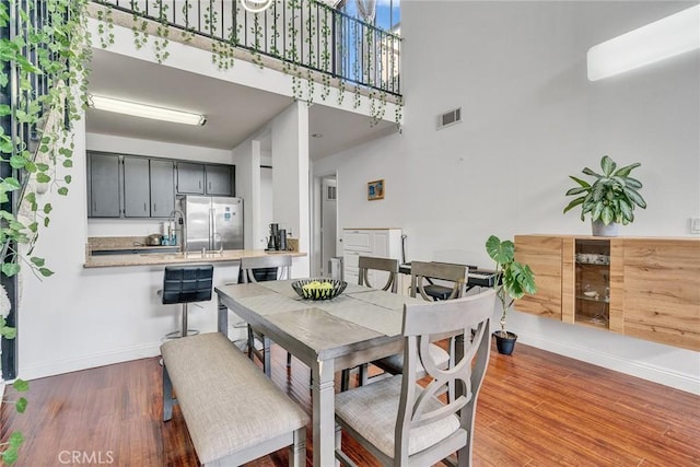 625 S Berendo St Unit 604, Los Angeles, CA 90005 - dining space with a high ceiling and dark wood-style floors