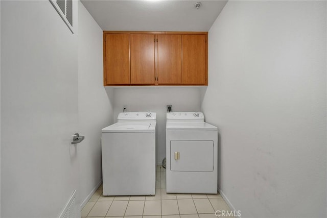 625 S Berendo St Unit 604, Los Angeles, CA 90005 - washroom with cabinet space, washer and dryer, and light tile patterned floors