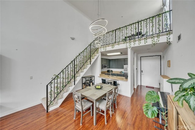 625 S Berendo St Unit 604, Los Angeles, CA 90005 - dining room with stairway, wood finished floors, and a high ceiling