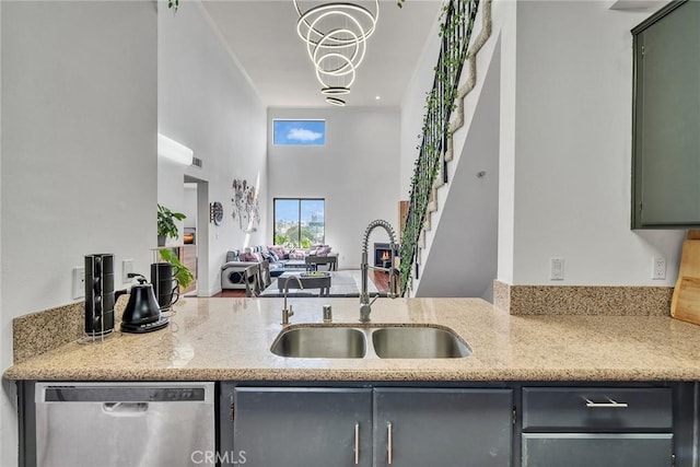 625 S Berendo St Unit 604, Los Angeles, CA 90005 - kitchen featuring dishwasher, light stone counters, a high ceiling, open floor plan, and gray cabinets